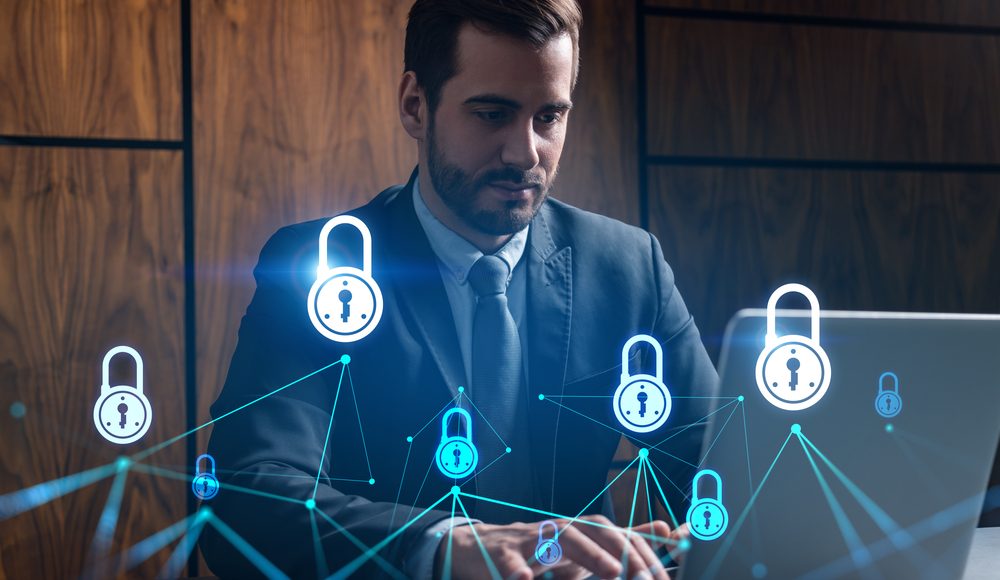 Businessman,In,Office,Working,With,Laptop,,Develop,Data,Protection,System