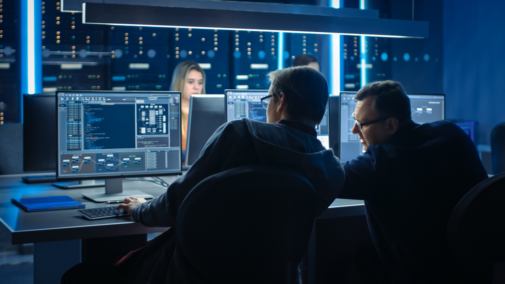 Team,Of,It,Programers,Working,On,Desktop,Computers,In,Data