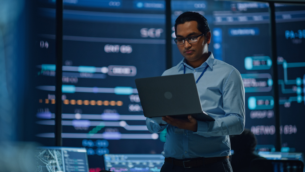 Young,Multiethnic,Male,Government,Employee,Uses,Laptop,Computer,In,System