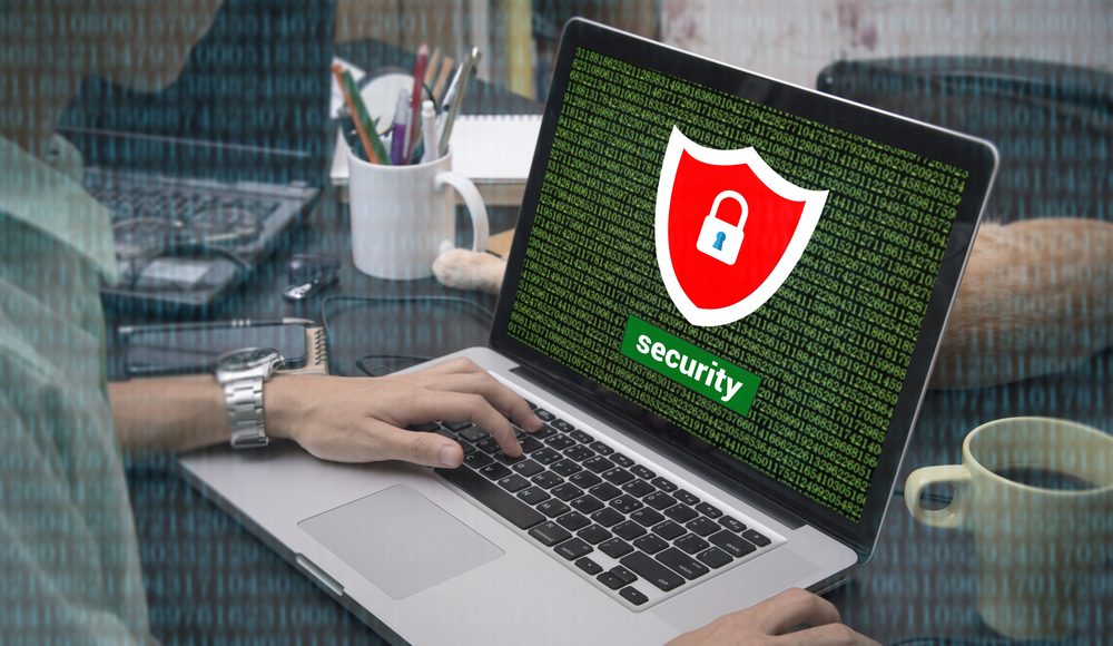 Business,Hand,Typing,On,A,Laptop,Keyboard,With,Cyber,Security