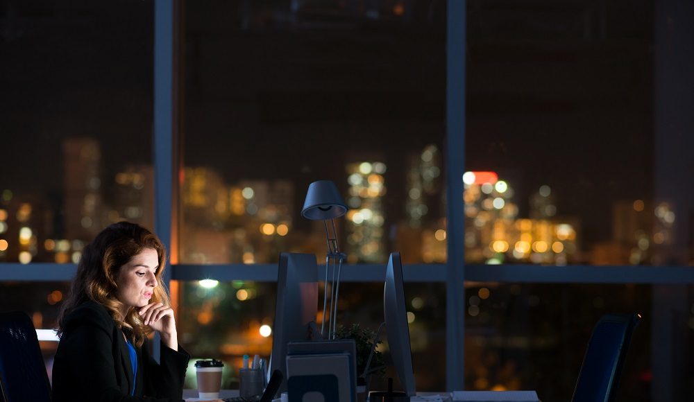 Pretty,Business,Woman,Working,Alone,In,Dark,Office