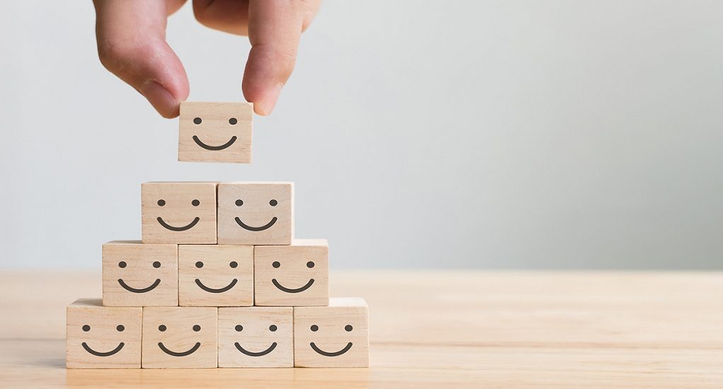 Hand,Putting,Wooden,Cube,Block,Shape,With,Icon,Face,Smiley,