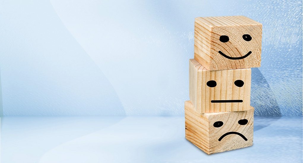 Wooden,Blocks,With,The,Happy,Face,Symbol,On,The,Table