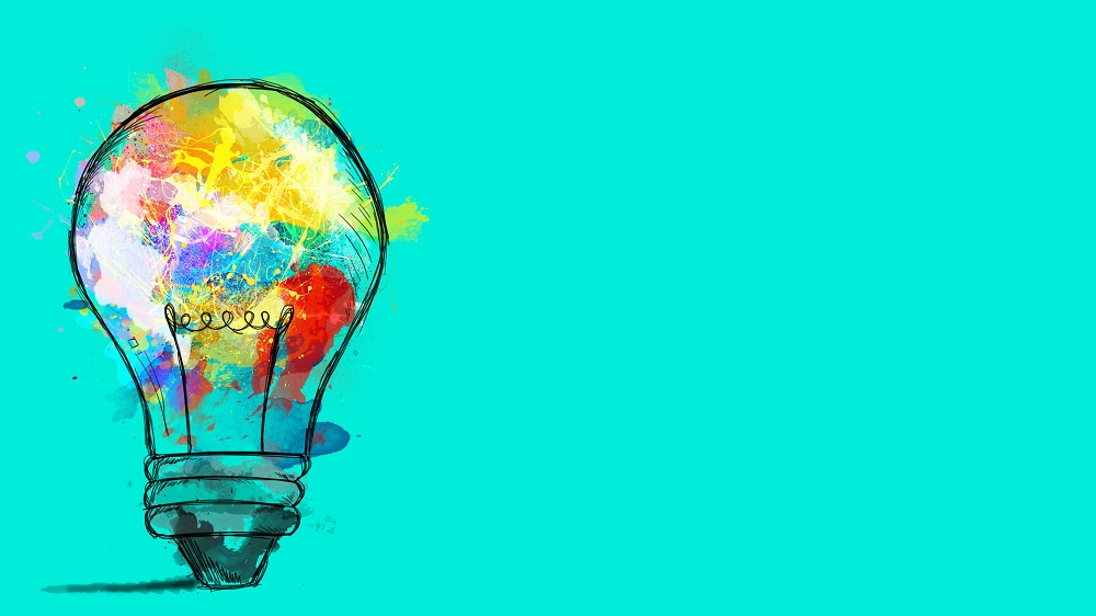 Big,Stylized,Light,Bulb,On,Cyan,Background,Drawn,With,Splashes