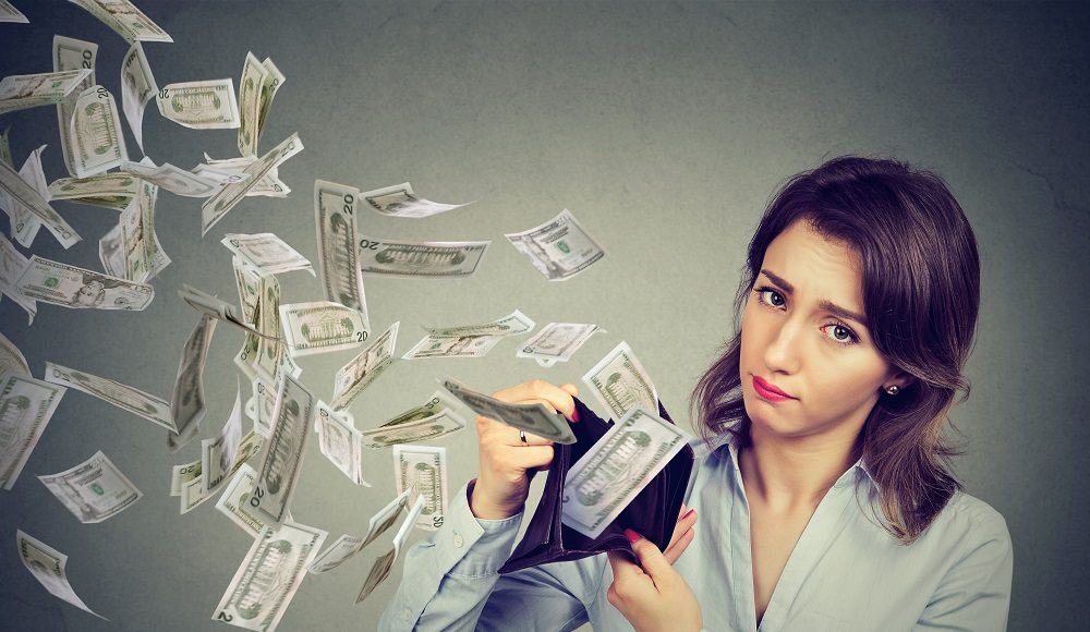 Sad,Woman,Showing,Her,Wallet,With,Money,Dollar,Banknotes,Flying