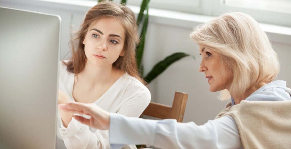 Senior,And,Young,Female,Colleagues,Discuss,Online,Project,Look,At