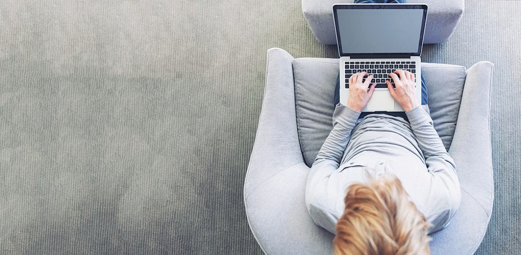 Top,Down,View,Of,Young,Blond,Person,Typing,On,Laptop