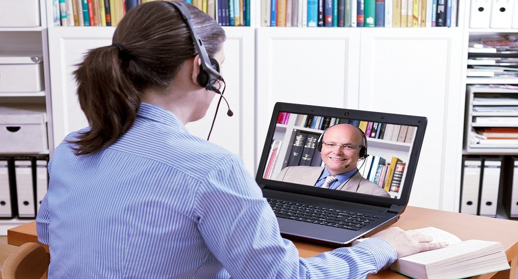 Woman,With,A,Headset,In,Front,Of,Her,Laptop,And
