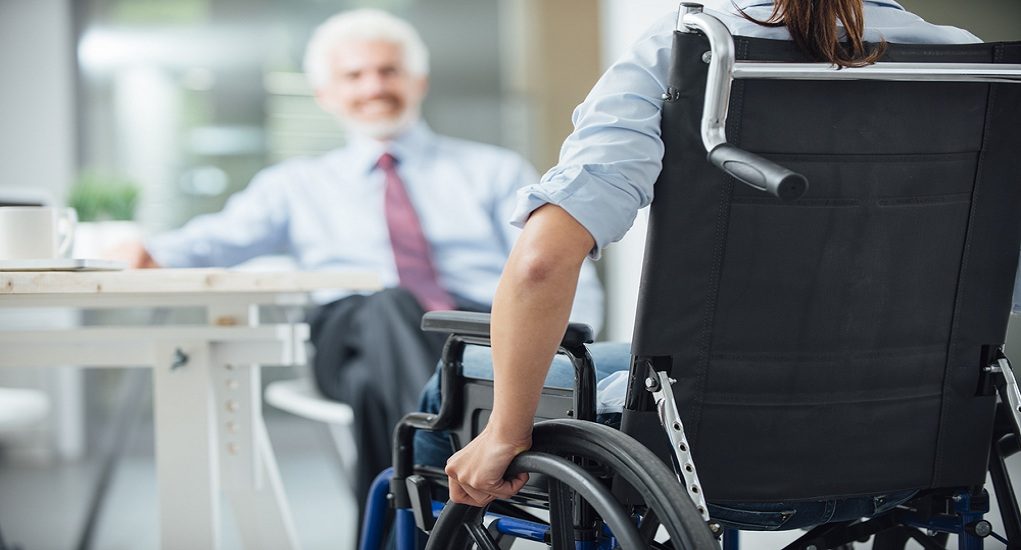 Disabled,Woman,Having,A,Business,Meeting,With,A,Businessman,Rear