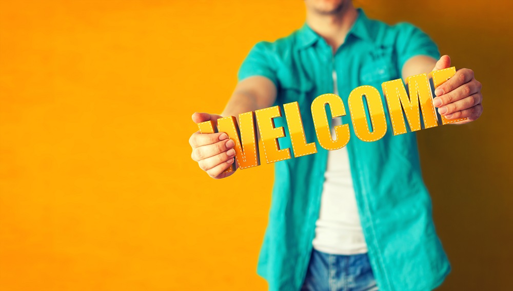 Man,Holds,Word,Welcome,On,Bright,Colorful,Background
